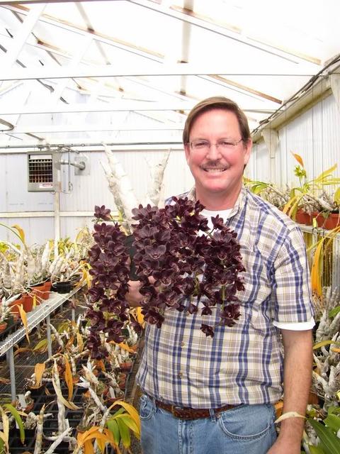 Fred Clarke and his black orchid FCC Fredclarkeara